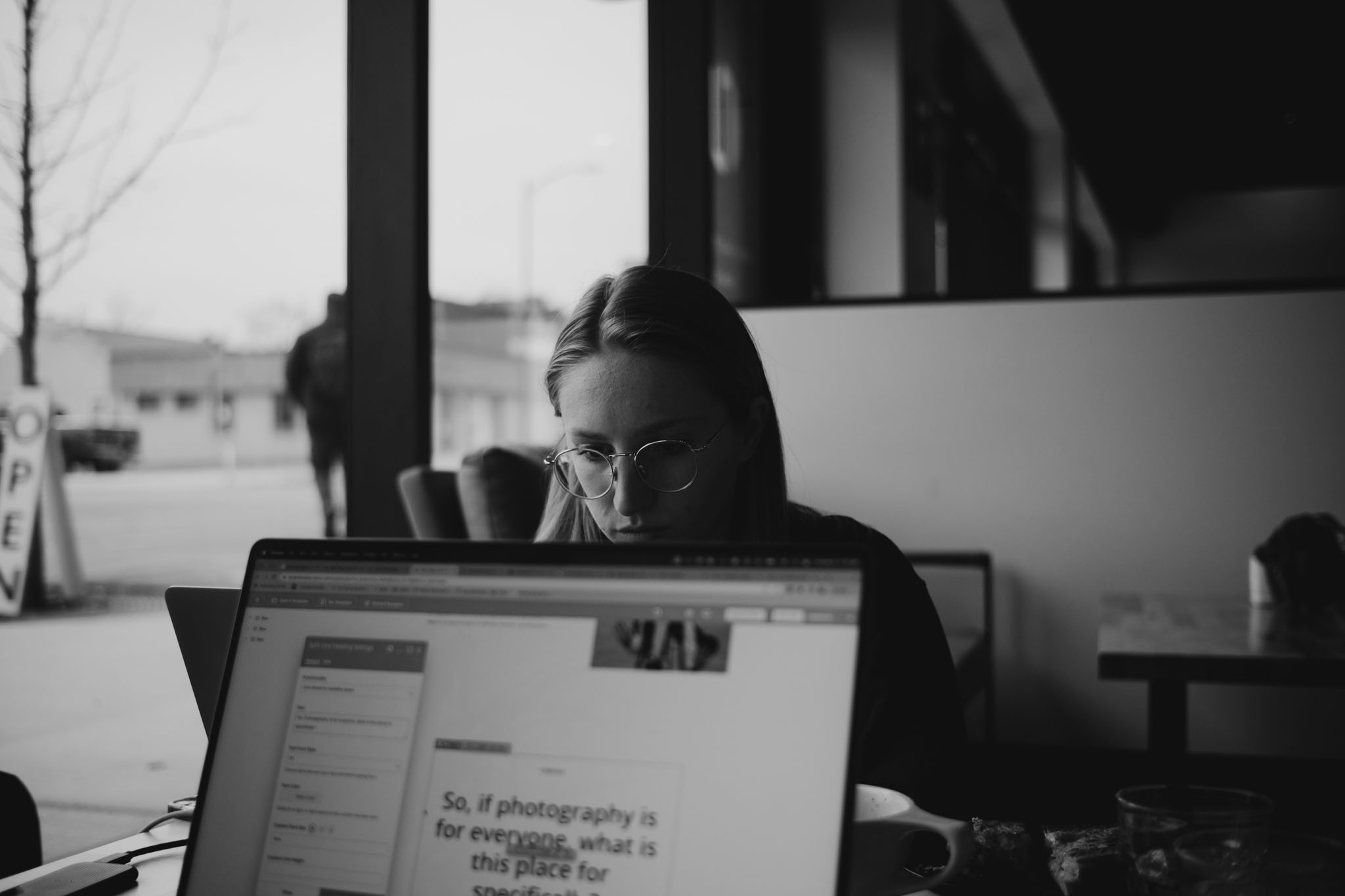 Photographers gathered around laptops at a warm community workshop session