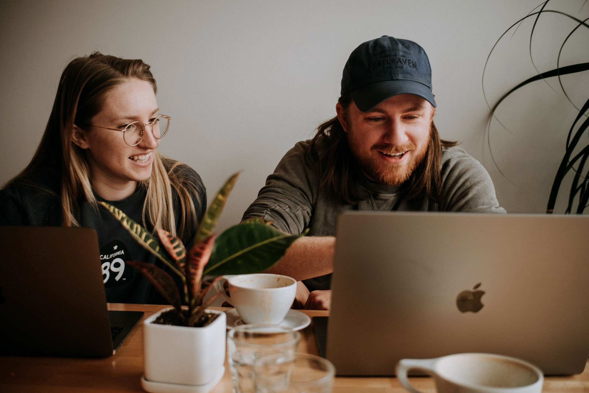 Photographers gathered at a community editing and learning session with laptops